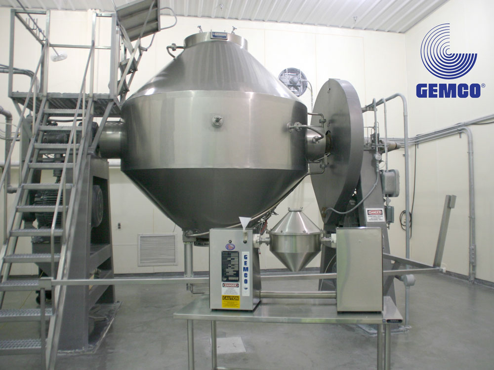 A large stainless steel machine in a factory.